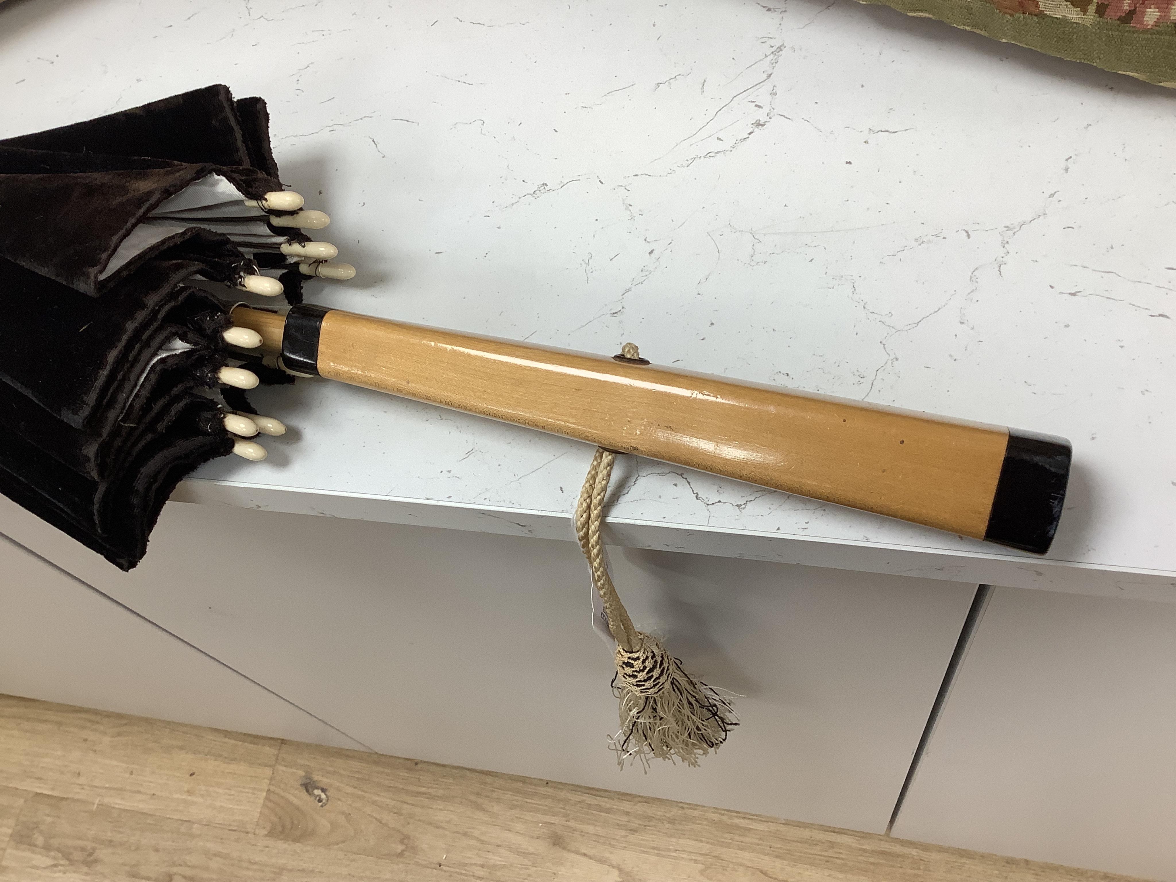 An unusual early 20th century cream silk and black velvet parasol and silk corded tassel. 64cm high. Condition - good